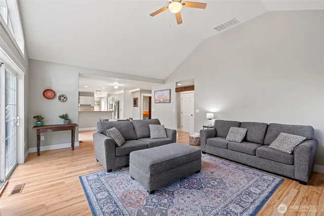 a living room with furniture and a wooden floor