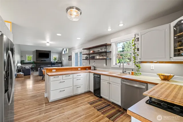 a kitchen with stainless steel appliances granite countertop a sink and cabinets