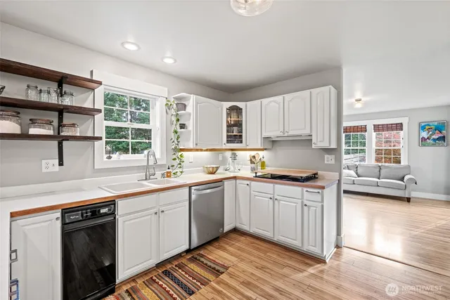 a kitchen with stainless steel appliances granite countertop a sink and cabinets