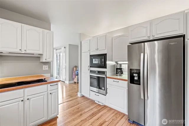 a kitchen with stainless steel appliances a refrigerator stove and microwave