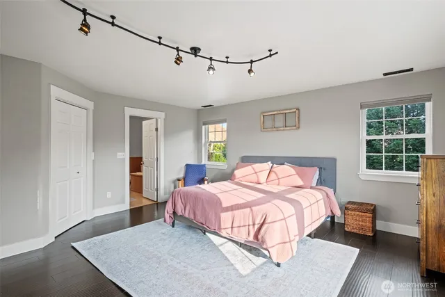 a bedroom with a bed lamp and a window