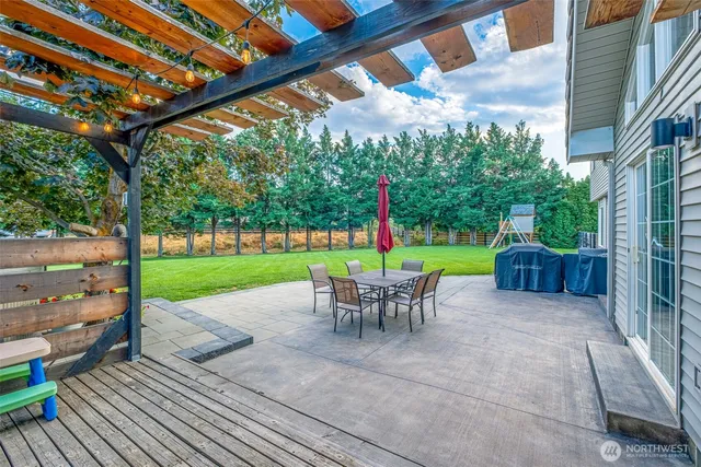 a view of a chairs and backyard with a slide