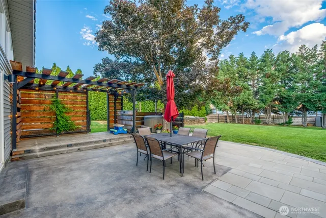 a view of a chairs and table in backyard of the house