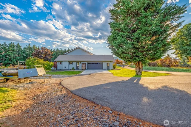 a view of a house with swimming pool and yard with trees