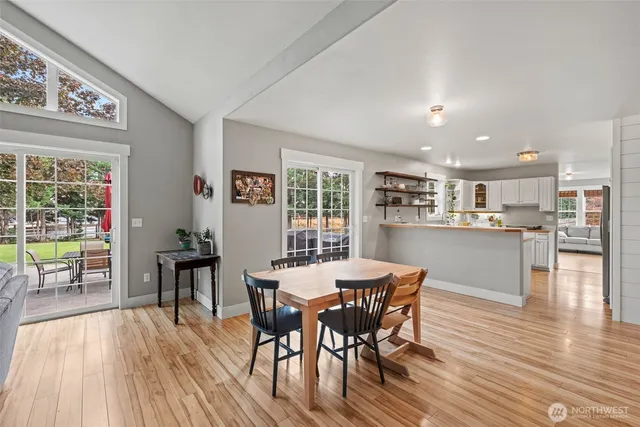 a dining room with furniture and wooden floor