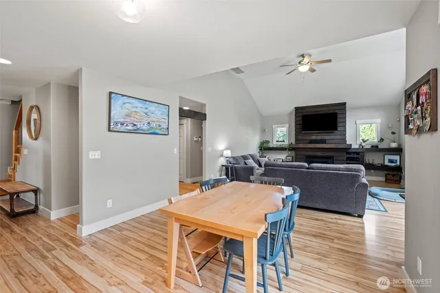 a living room with furniture a flat screen tv and kitchen view