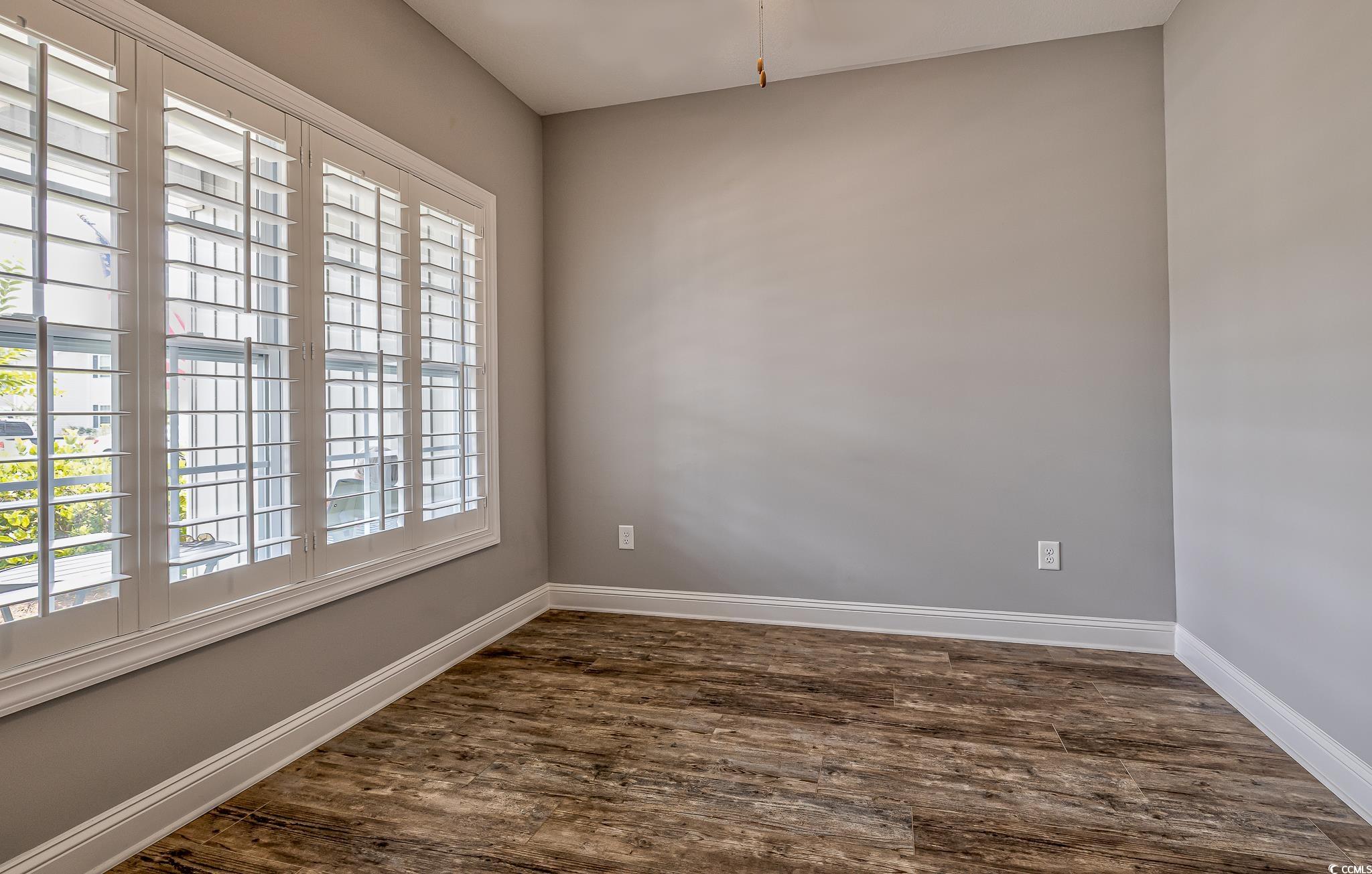 648 Sunnyside Drive, Unit 102 Murrells Inlet, SC 29576 - Photo 14 of 21 Empty room featuring dark wood-style floors and baseboards