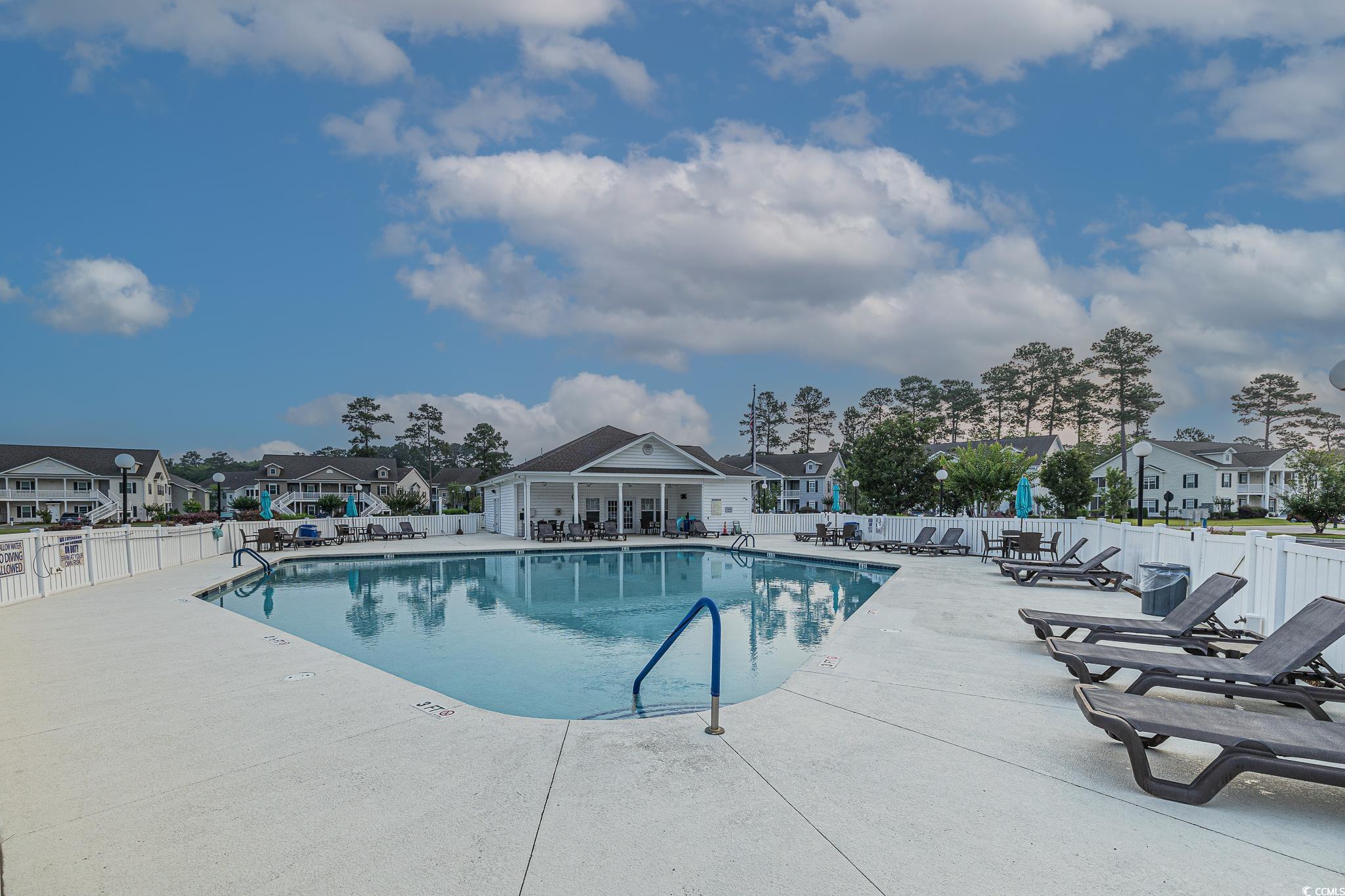 648 Sunnyside Drive, Unit 102 Murrells Inlet, SC 29576 - Photo 2 of 21 Community pool featuring a patio and a residential view