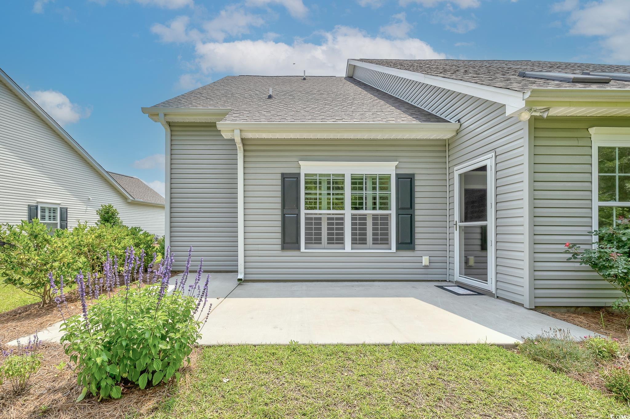 648 Sunnyside Drive, Unit 102 Murrells Inlet, SC 29576 - Photo 21 of 21 Back of property featuring a patio area and a shingled roof