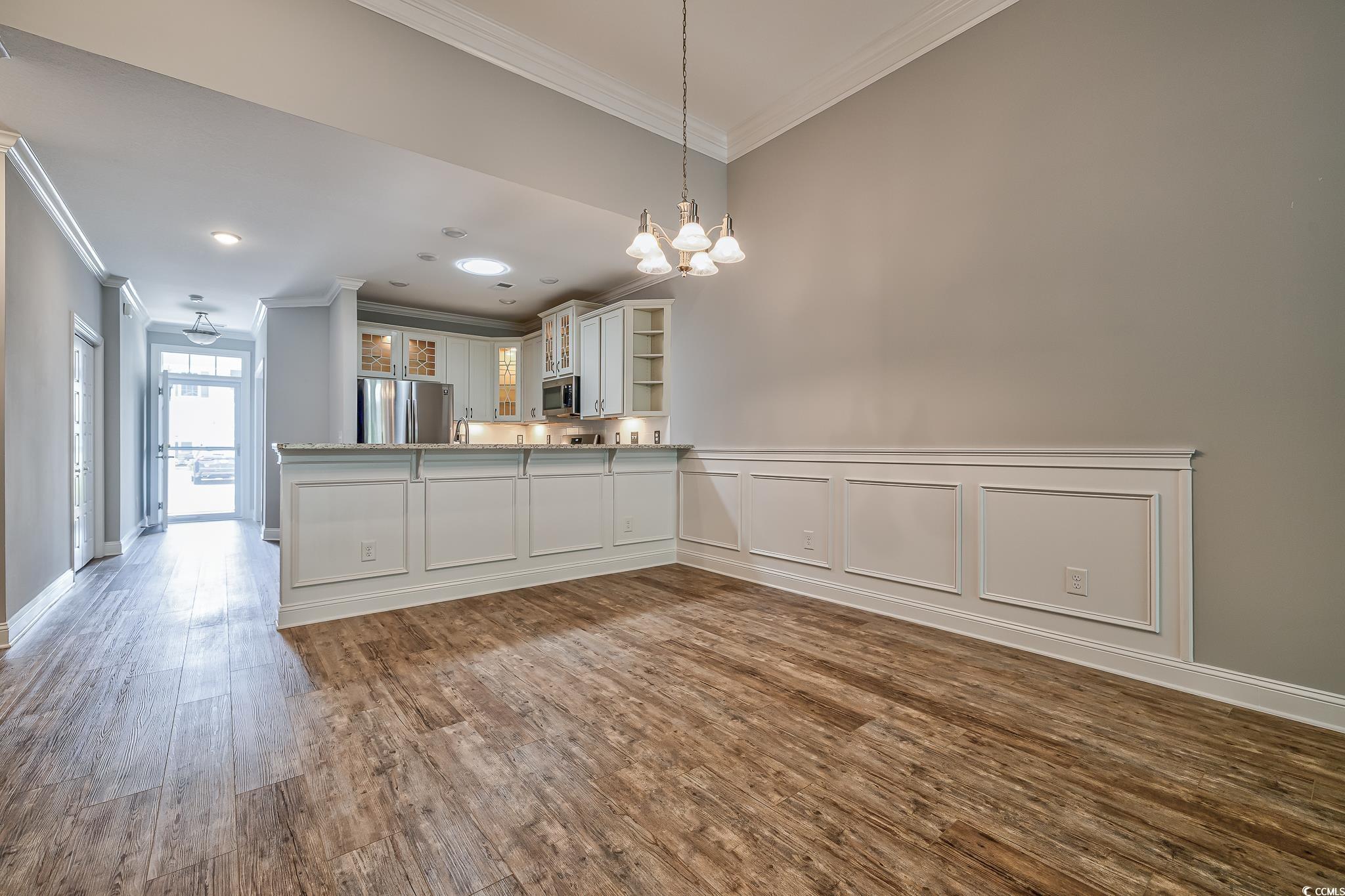 648 Sunnyside Drive, Unit 102 Murrells Inlet, SC 29576 - Photo 6 of 21 Kitchen with stainless steel appliances, crown molding, dark wood-style flooring, a chandelier, and open shelves