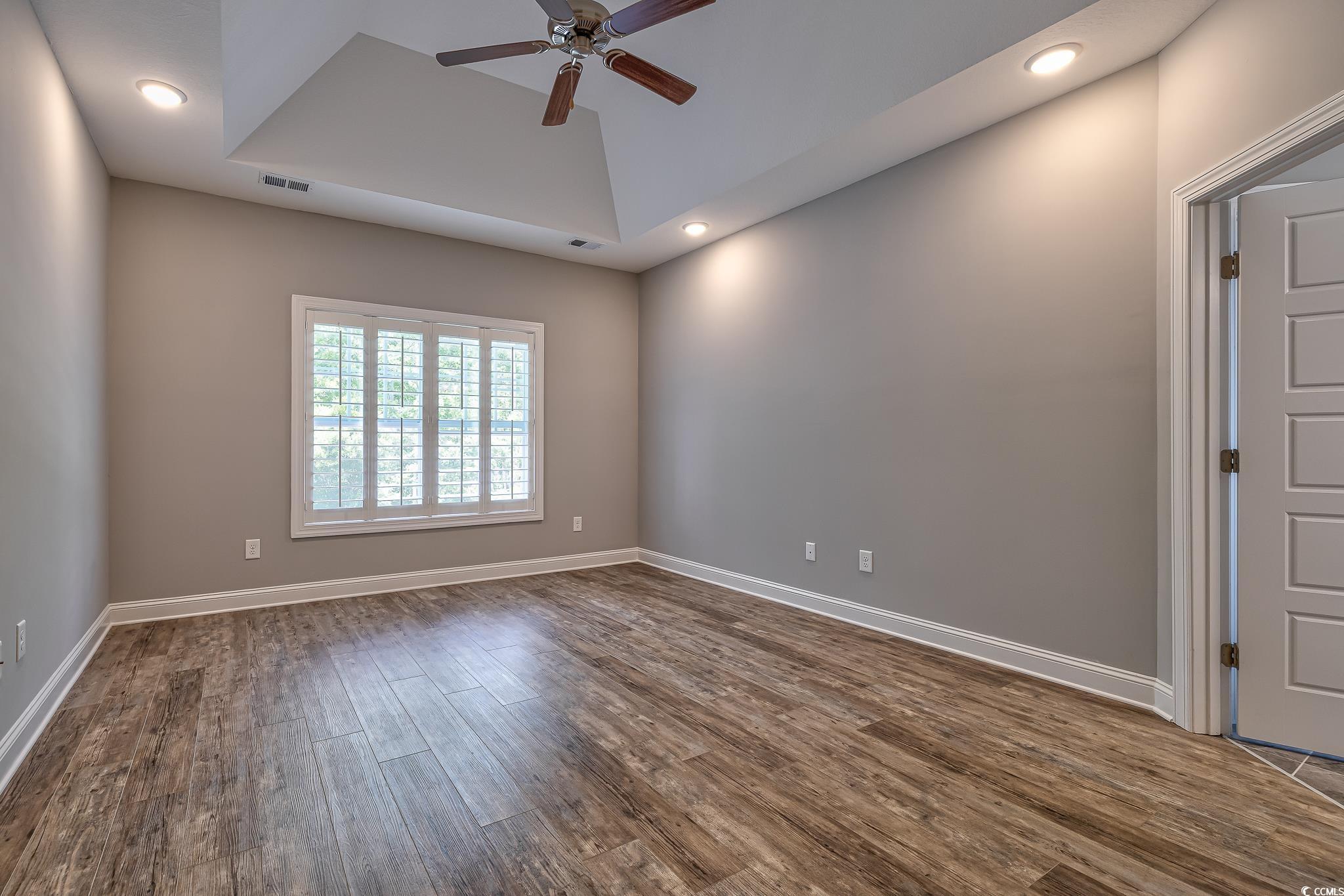 648 Sunnyside Drive, Unit 102 Murrells Inlet, SC 29576 - Photo 7 of 21 Empty room with a ceiling fan, dark wood finished floors, recessed lighting, and baseboards