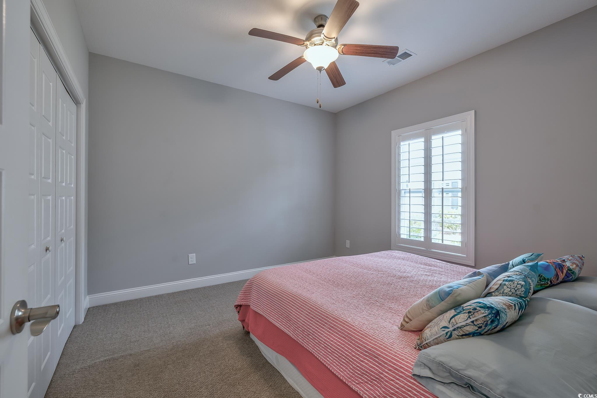 648 Sunnyside Drive, Unit 102 Murrells Inlet, SC 29576 - Photo 10 of 21 Bedroom with a closet, carpet floors, baseboards, and ceiling fan