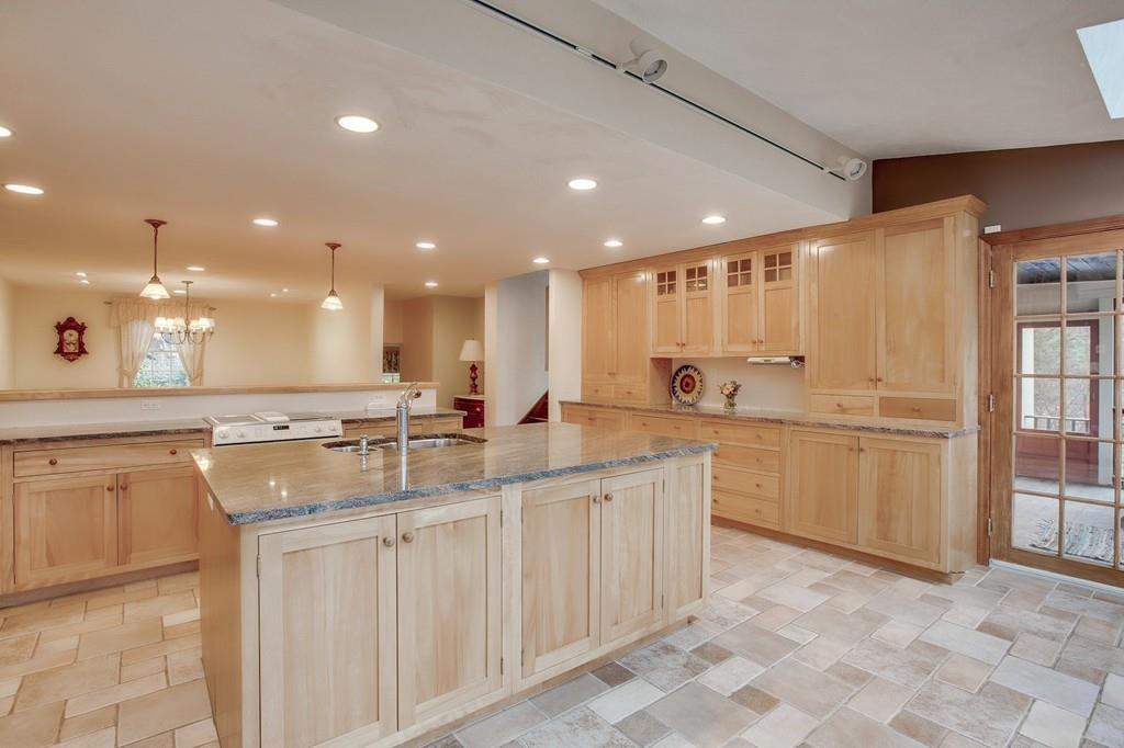 250 Old Littleton Road Harvard, MA 01451 - Photo 20 of 35 a open kitchen with kitchen island a sink stainless steel appliances and cabinets