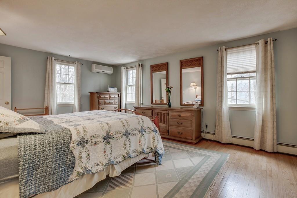 250 Old Littleton Road Harvard, MA 01451 - Photo 25 of 35 a spacious bedroom with a bed and wooden floor