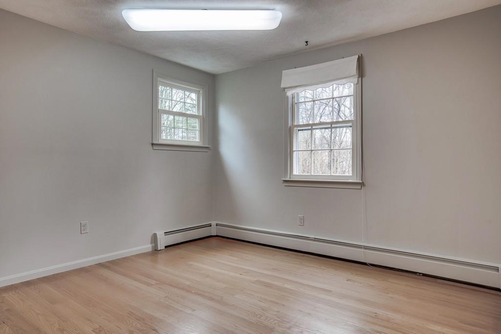 250 Old Littleton Road Harvard, MA 01451 - Photo 27 of 35 an empty room with wooden floor and windows