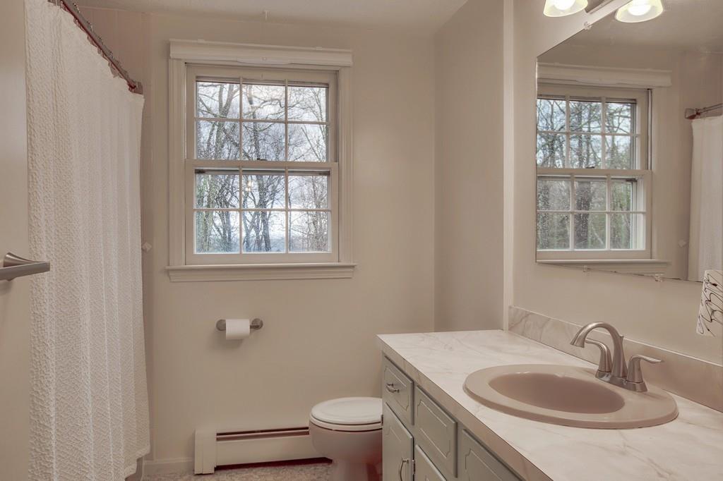 250 Old Littleton Road Harvard, MA 01451 - Photo 30 of 35 a bathroom with a sink toilet and window