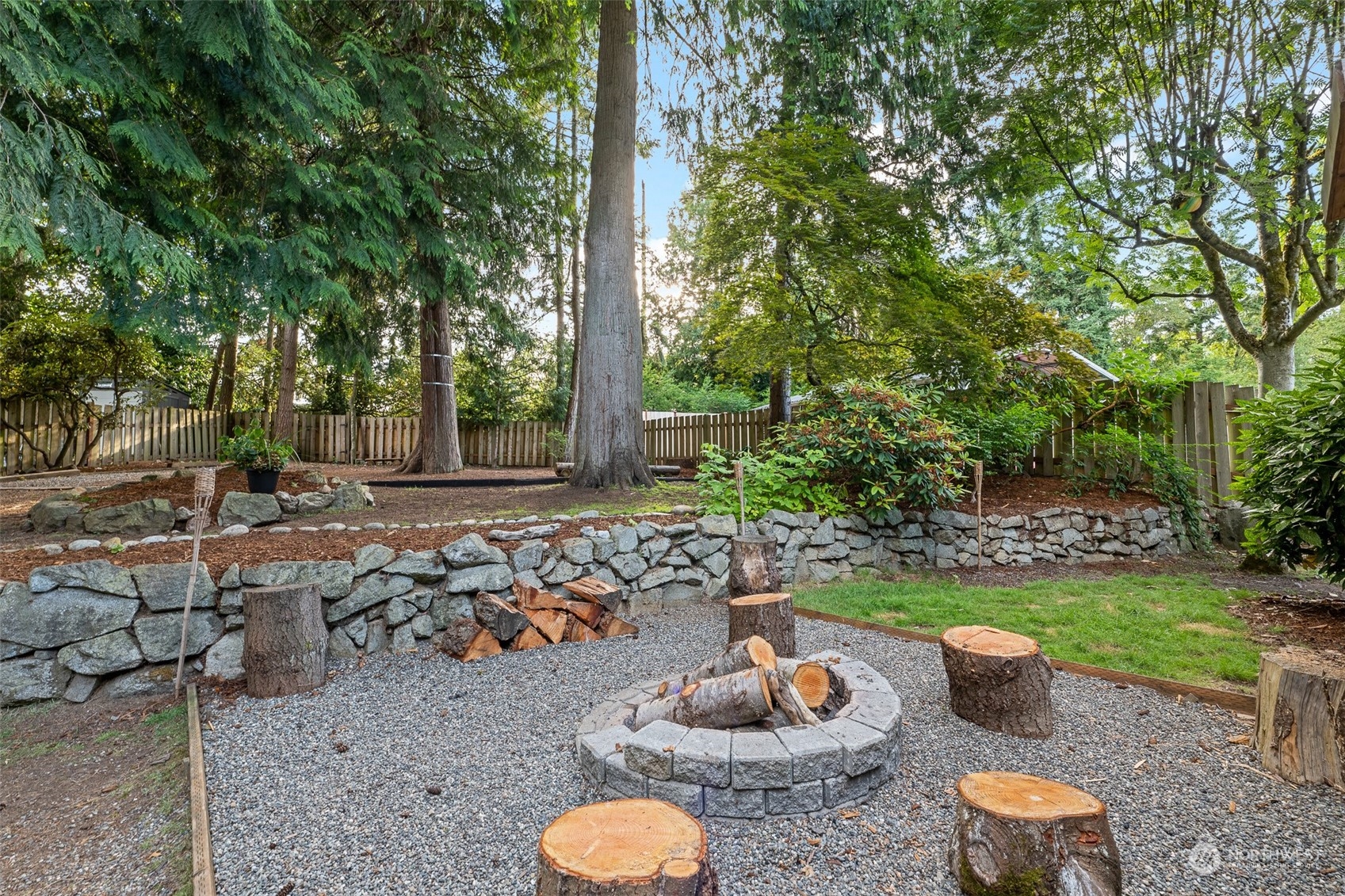 5408 25th Avenue Northwest Gig Harbor, WA 98335 - Photo 29 of 31 a view of a backyard with table and chairs potted plants and large tree