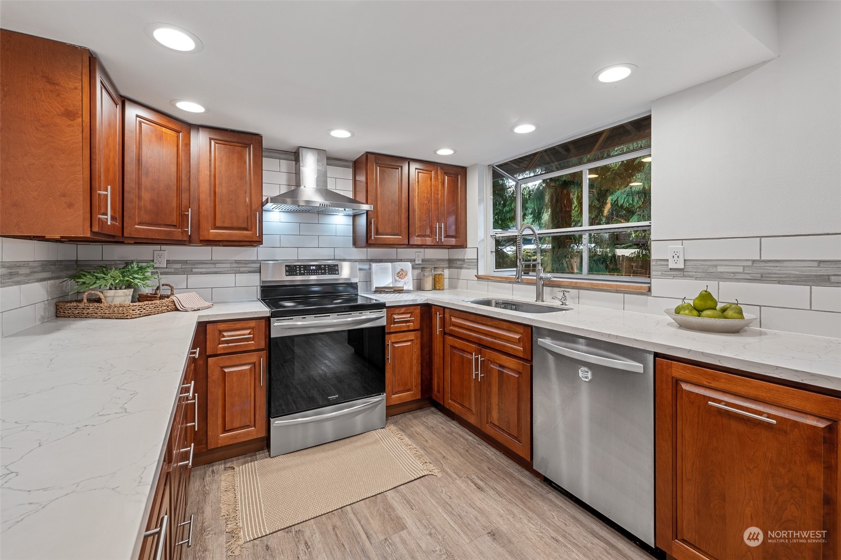 5408 25th Avenue Northwest Gig Harbor, WA 98335 - Photo 5 of 31 a kitchen with granite countertop wooden cabinets stainless steel appliances and a counter top space