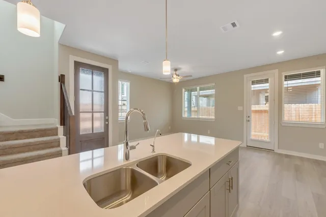 a kitchen with a sink and chandelier