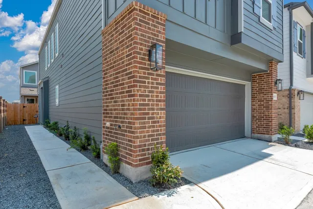 a view of a street with potted plants