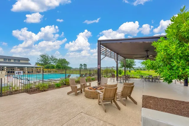 a view of a livingroom with furniture wooden floor and a large window