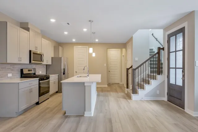 a view of kitchen with sink microwave and stove