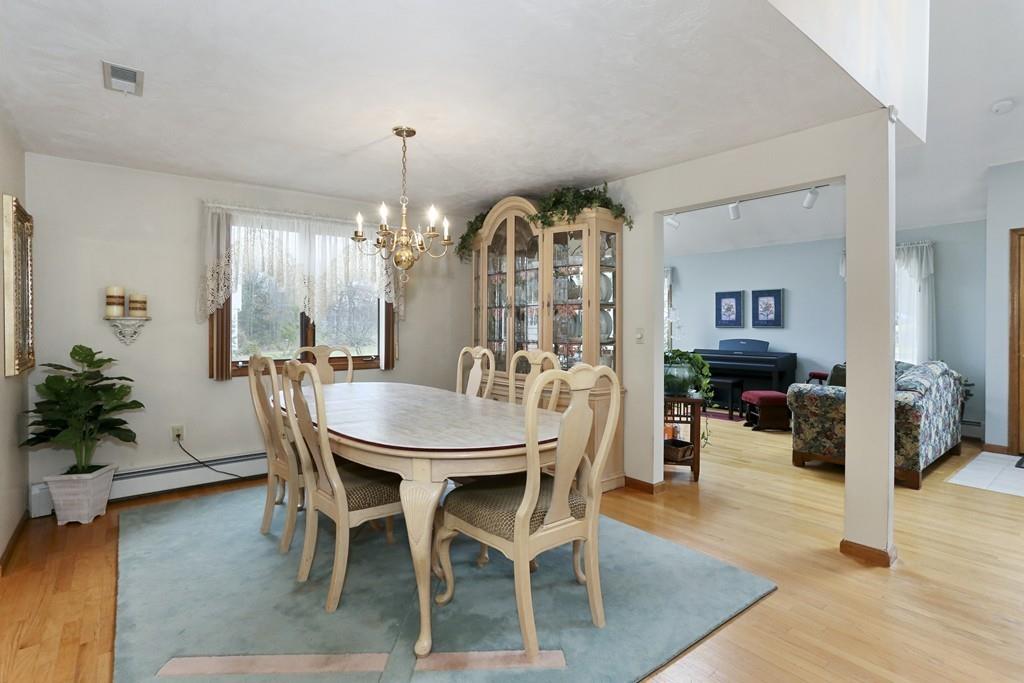 8 Pheasant Hill Road Bellingham, MA 02019 - Photo 3 of 15 a view of a dining room with furniture and wooden floor