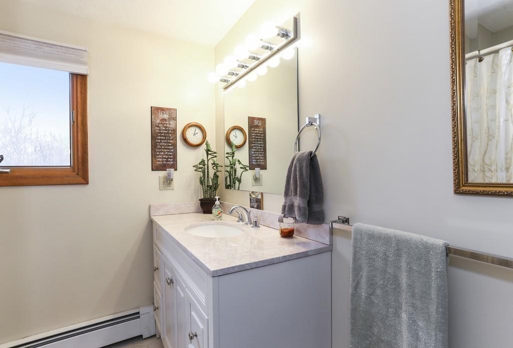 8 Pheasant Hill Road Bellingham, MA 02019 - Photo 8 of 15 a bathroom with a sink and a mirror