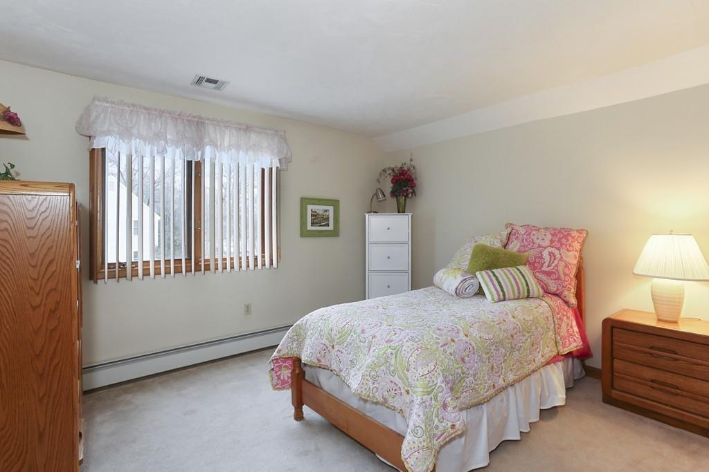 8 Pheasant Hill Road Bellingham, MA 02019 - Photo 10 of 15 a bedroom with a bed lamp and window