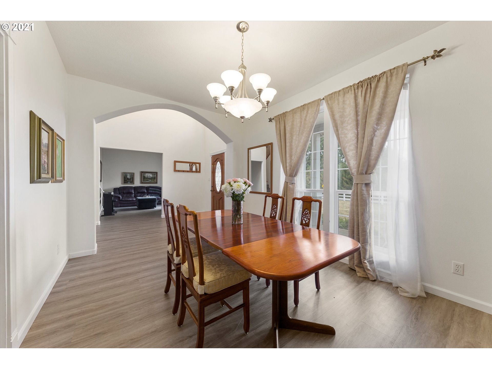 20925 South Ridge Road Oregon City, OR 97045 - Photo 3 of 32 a dining room with furniture a chandelier and wooden floor