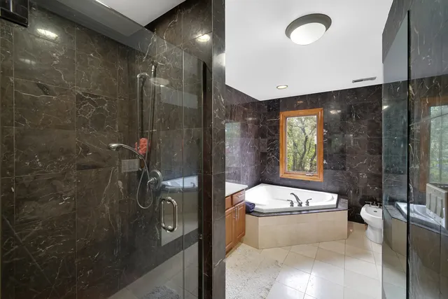 a bathroom with a granite countertop sink a toilet a mirror and shower