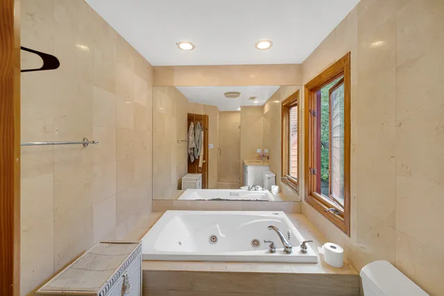 a bathroom with a bathtub and a shower