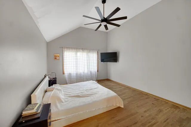 a bedroom with a bed and a tv