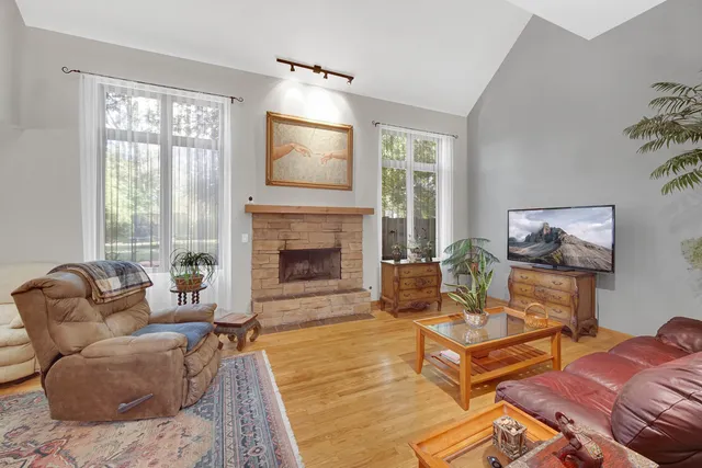 a living room with furniture fireplace and window