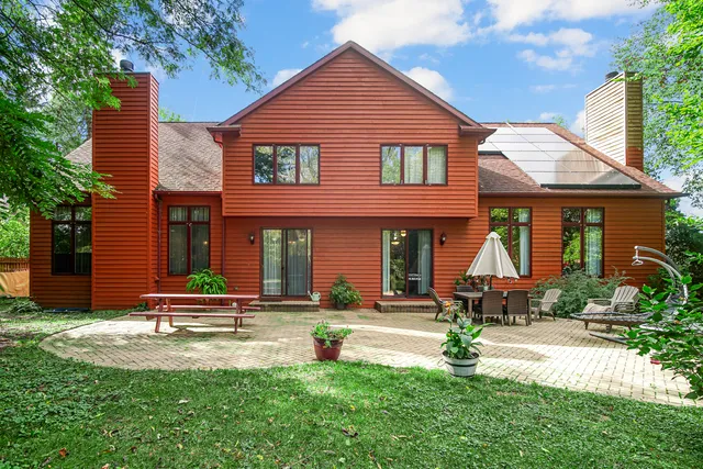 a view of a house with swimming pool and sitting area