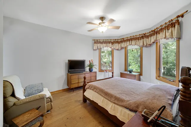 a spacious bedroom with a bed and large windows