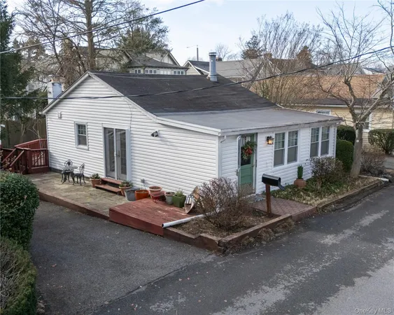 a backyard of a house with table and chairs
