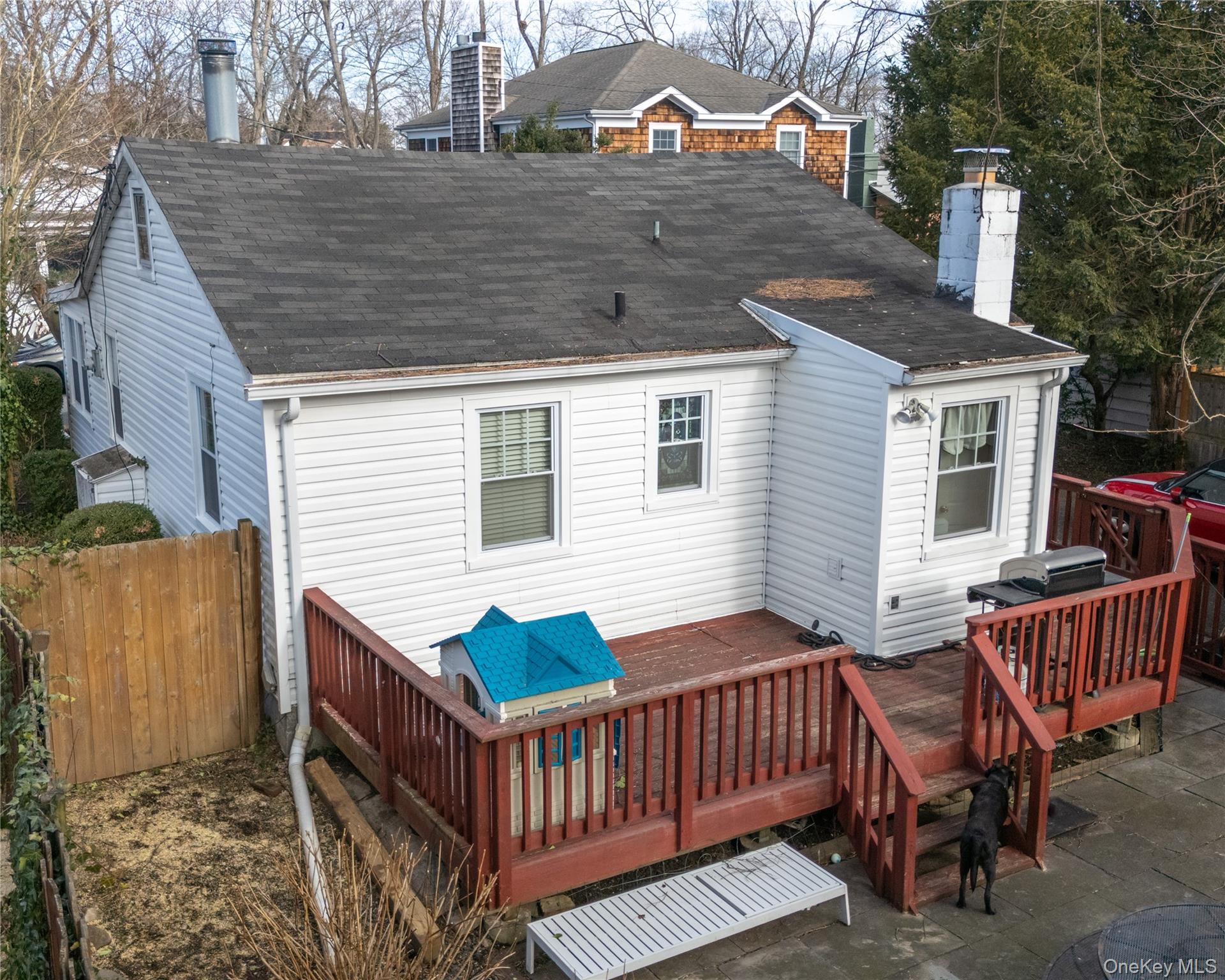 8 Ridgeland Terrace Rye, NY 10580 - Photo 2 of 22 Back of property with a chimney, a wooden deck, and a shingled roof