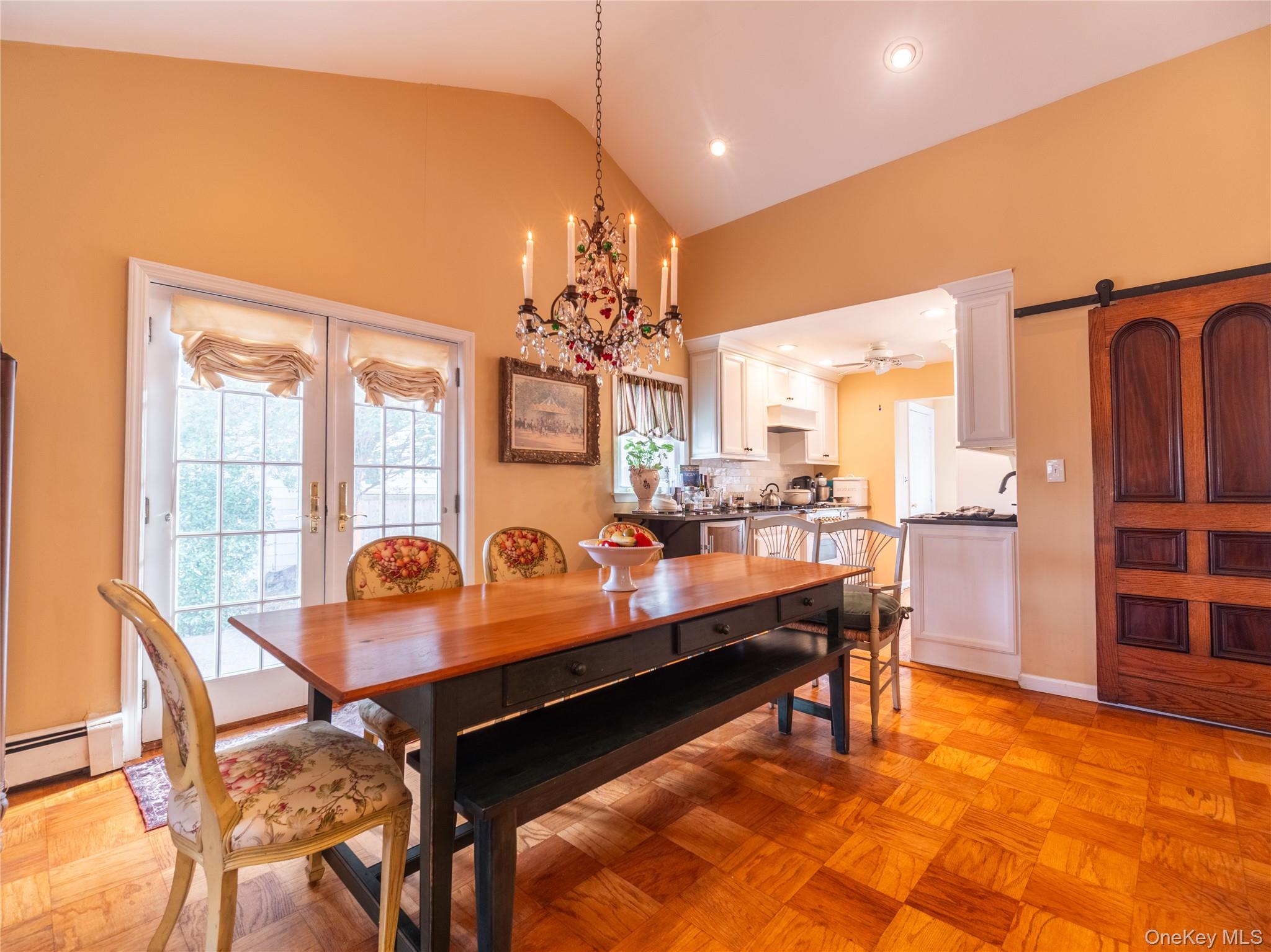 8 Ridgeland Terrace Rye, NY 10580 - Photo 7 of 22 Dining area with french doors, a baseboard heating unit, a barn door, high vaulted ceiling, and recessed lighting