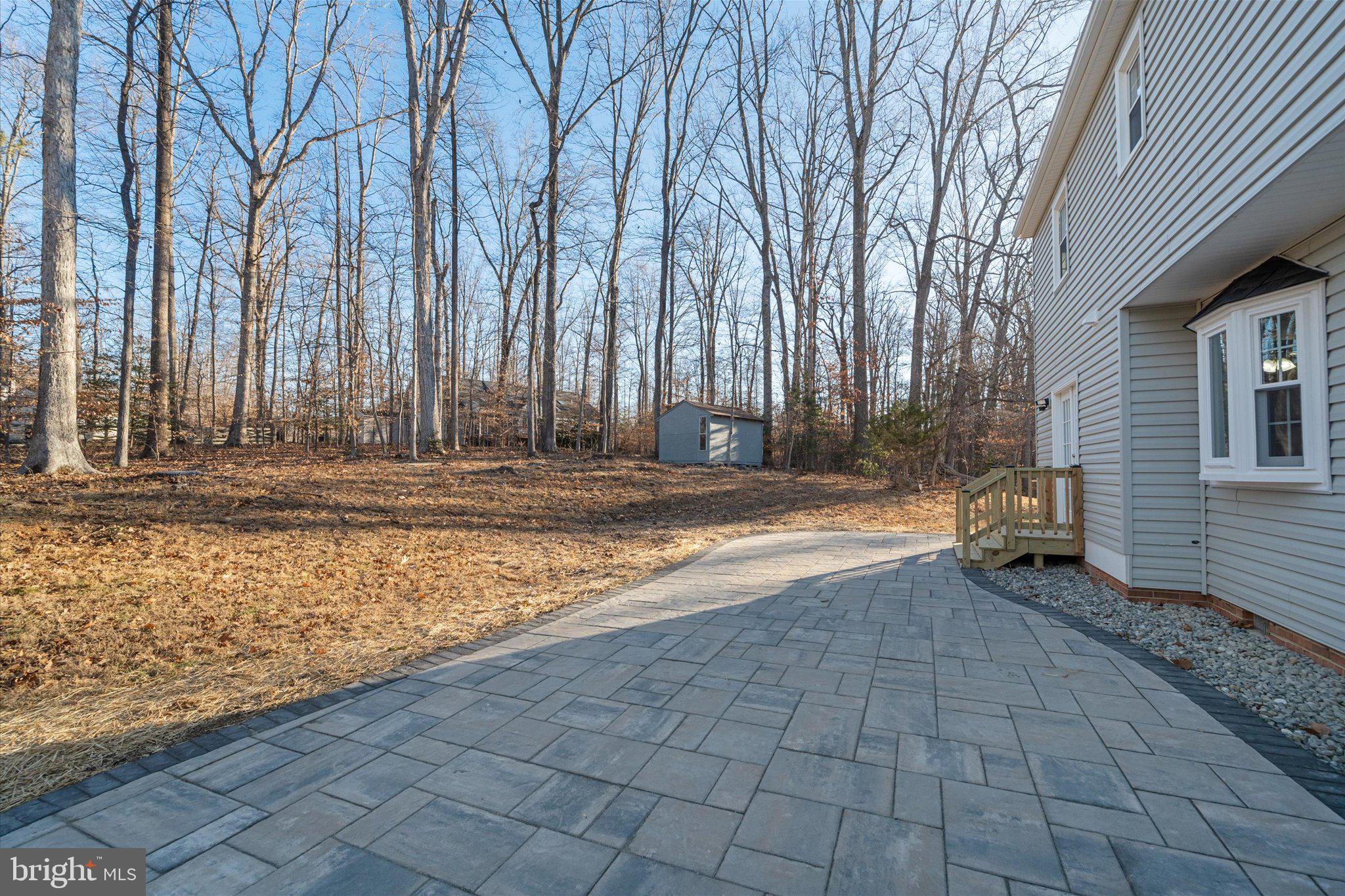 8016 Stillbrooke Road Manassas, VA 20112 - Photo 11 of 41 a view of a house with backyard and trees