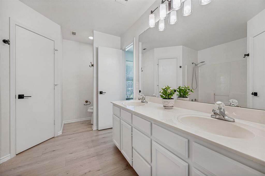 629 Concho Drive Oak Point, TX 75068 - Photo 20 of 35 a spacious bathroom with a double vanity sink mirror and shower