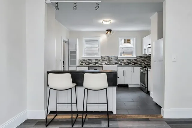 a bathroom with a sink vanity and a mirror