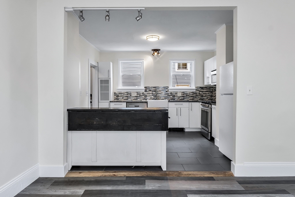 6 Dexter Street Haverhill, MA 01830 - Photo 13 of 42 a view of living room with stainless steel appliances kitchen island granite countertop a stove and a sink
