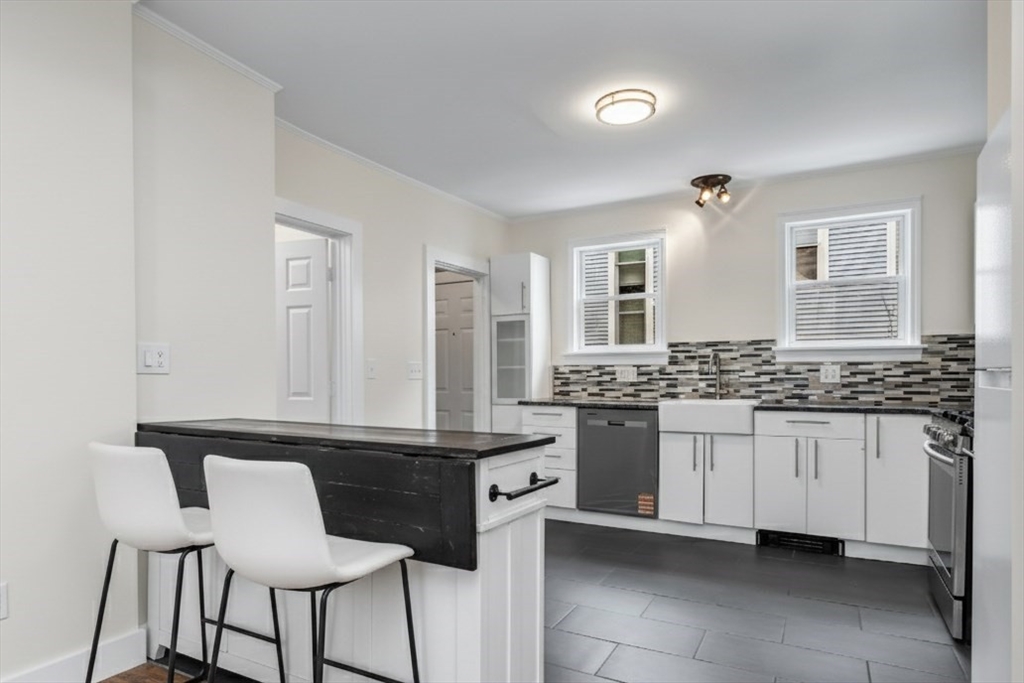 6 Dexter Street Haverhill, MA 01830 - Photo 14 of 42 a kitchen with a sink and chairs