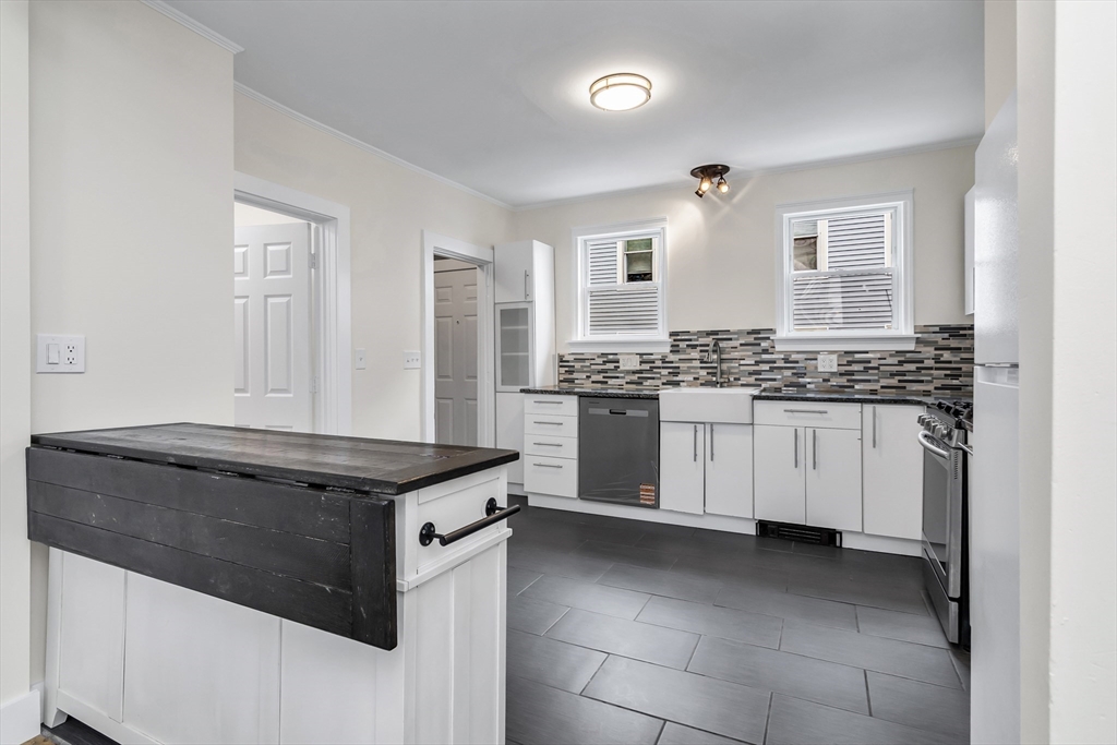 6 Dexter Street Haverhill, MA 01830 - Photo 15 of 42 a kitchen with stainless steel appliances granite countertop a stove a sink and a refrigerator