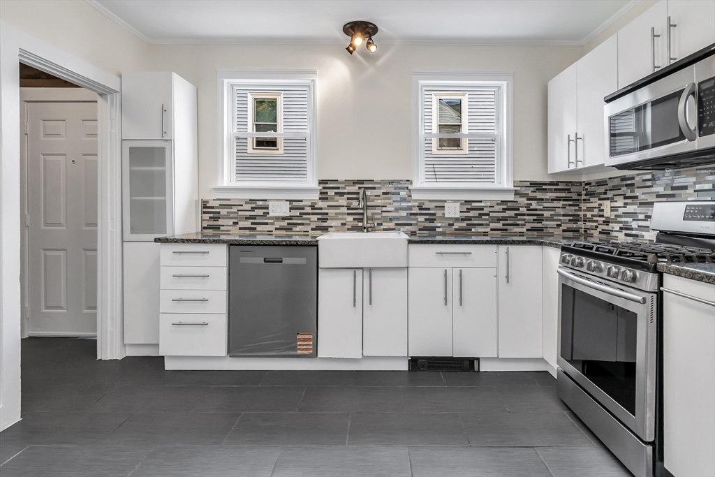 6 Dexter Street Haverhill, MA 01830 - Photo 16 of 42 a kitchen with stainless steel appliances granite countertop a stove and a sink