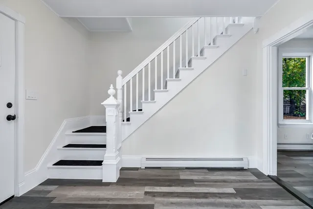 a front view of a house with a tree