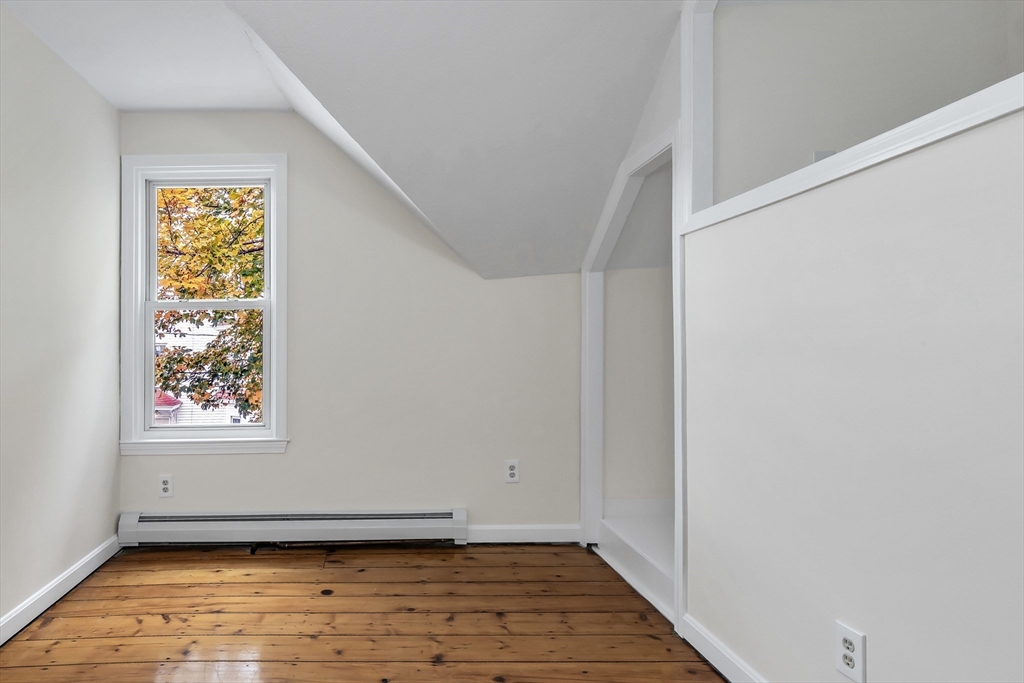 6 Dexter Street Haverhill, MA 01830 - Photo 31 of 42 a view of an empty room with wooden floor and a window