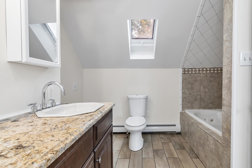 6 Dexter Street Haverhill, MA 01830 - Photo 38 of 42 a bathroom with a granite countertop sink a toilet and bathtub