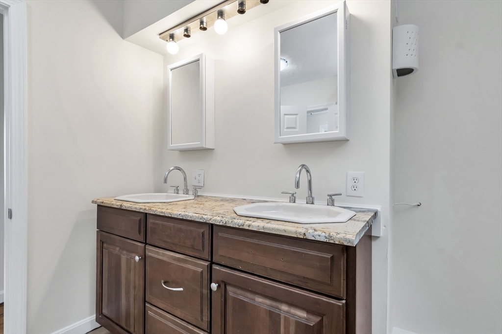 6 Dexter Street Haverhill, MA 01830 - Photo 39 of 42 a bathroom with a granite countertop sink and a mirror